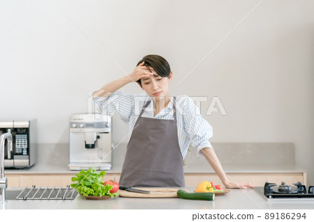 Kitchen woman headache tired fever 89186294