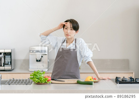 Kitchen woman headache tired fever 89186295