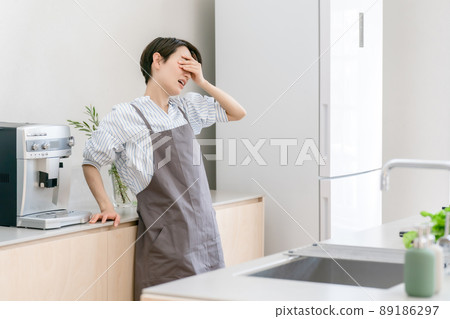 Kitchen woman headache tired fever 89186297