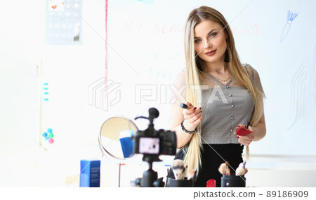 Beautiful woman blogger present beauty products for facial makeup on camera 89186909