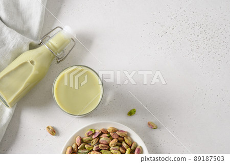 Pistachio milk in glass, lactose free. Vegan plant based milk. 89187503