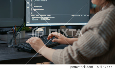 Closeup of caucasian software coder hands typing on keyboard in front of computer screens with programming interface. Database developer sitting at desk writing algorithm for it agency. Closeup of caucasian software coder hands typing on keyboard in front of computer screens with programming interface. Database developer sitting at desk writing algorithm for it agency. 89187537
