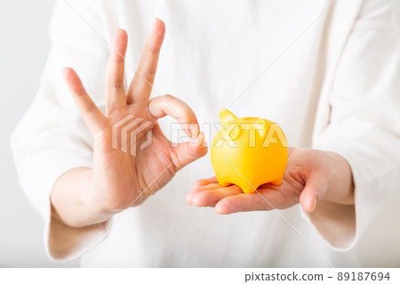 Middle woman with piggy bank 89187694