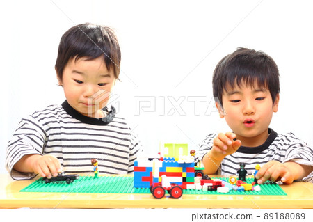 Brothers playing blocks at the table Brothers playing blocks at the table 89188089