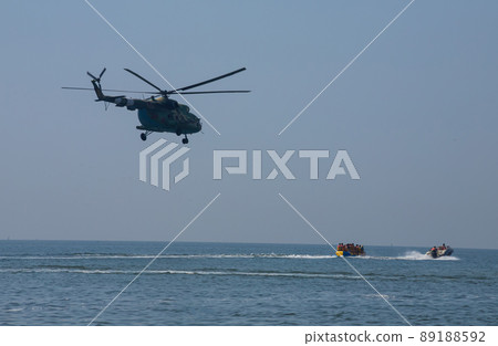 The military helicopter against the blue sky The military helicopter against the blue sky 89188592