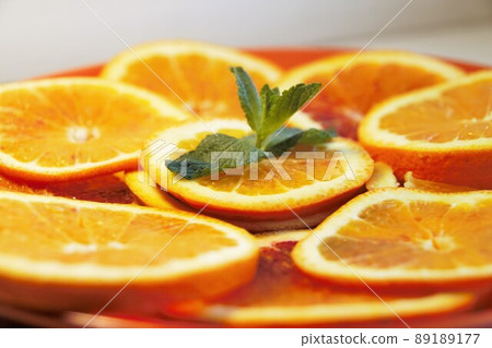 Orange slices with mint leaves Orange slices with mint leaves 89189177
