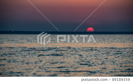 Beautiful red and orang sunset over the lake Beautiful red and orang sunset over the lake 89189359