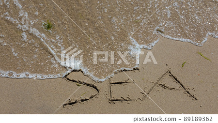 The inscription sea on the sand by the water and the rising wave, seashore beach vacation by the sea The inscription sea on the sand by the water and the rising wave, seashore beach vacation by the sea 89189362