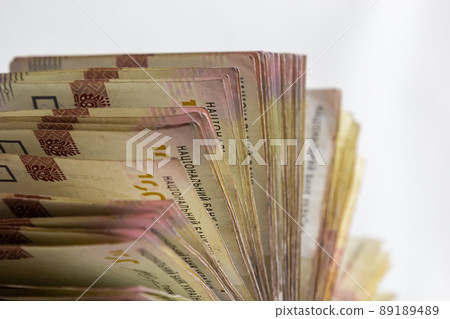 Ukrainian hryvnias bills lies isolated on white background with copy space stacked in fan close up. Payday time concept or financial operations Ukrainian hryvnias bills lies isolated on white background with copy space stacked in fan close up. Payday time concept or financial operations 89189489