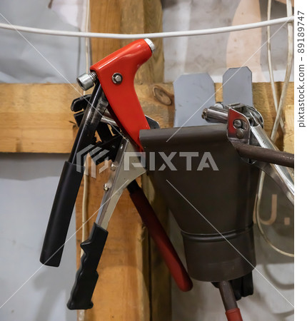 tools in the workshop drills, screwdrivers, scissors on the metal, on the shelf tools in the workshop drills, screwdrivers, scissors on the metal, on the shelf 89189747