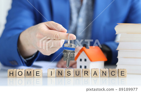 Insurance agent holds key to new house closeup Insurance agent holds key to new house closeup 89189977