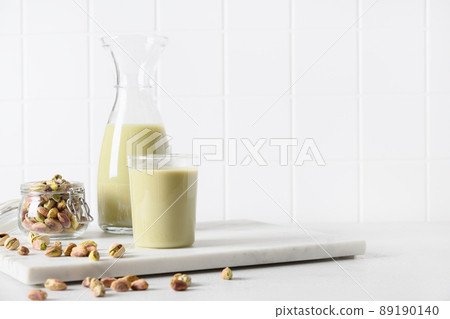 Pistachio milk in glass, lactose free. Vegan nutty plant based milk. 89190140