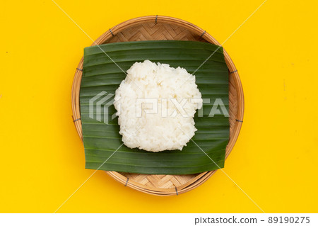 Sticky rice on banana leaf in bamboo plate 89190275