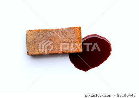 Brick with blood on white background. Brick with blood on white background. 89190443