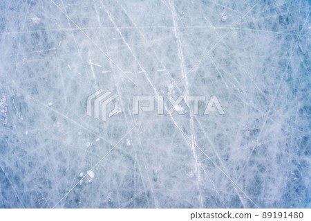 Ice background with marks from skating and hockey, blue texture of rink surface with scratches Ice background with marks from skating and hockey, blue texture of rink surface with scratches 89191480
