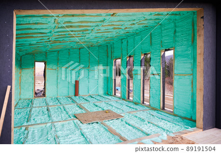 Wooden frame house in the Scandinavian style barnhouse thermal insulated by polyurethane foam. Construction and insulation concept. 89191504