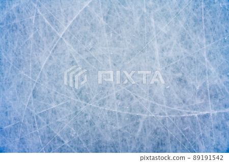 Ice background with marks from skating and hockey, blue texture of rink surface with scratches Ice background with marks from skating and hockey, blue texture of rink surface with scratches 89191542