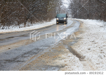 driving in winter after a snowfall, ice on the road, temperatures below zero driving in winter after a snowfall, ice on the road, temperatures below zero 89191912