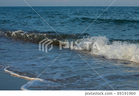 A large and strong storm wave of turquoise color with splashes of white foam runs and breaks A large and strong storm wave of turquoise color with splashes of white foam runs and breaks 89191960