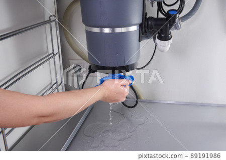 Waste disposal leak under a sink, broken garbage chopper 89191986