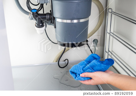 Waste disposal leak under a sink, broken garbage chopper 89192059