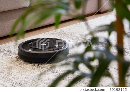 Robotic vacuum cleaner on the floor in cozy modern living room Robotic vacuum cleaner on the floor in cozy modern living room 89192135