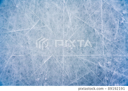 Ice background with marks from skating and hockey, blue texture of rink surface with scratches 89192191