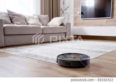 Robotic vacuum cleaner on the floor in cozy modern living room Robotic vacuum cleaner on the floor in cozy modern living room 89192422