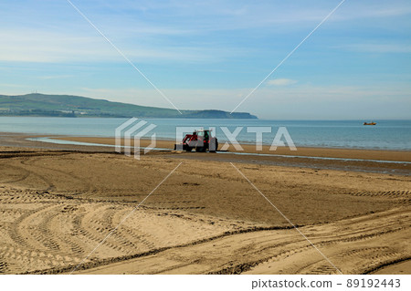 Tractor Levelling Sand on a Coastal Beach 89192443