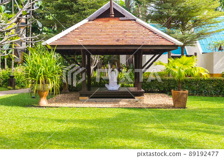 Woman in gazebo practicing yoga in Thailand in Asia Woman in gazebo practicing yoga in Thailand in Asia 89192477