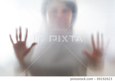 Diffused silhouette of female hands, view with shadow through plastic 89192623