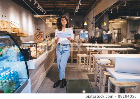 Full length portrait of self employed woman accounting in grocery service industry Full length portrait of self employed woman accounting in grocery service industry 89194055