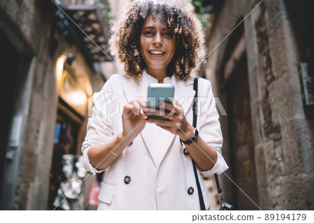 Happy Caucasian tourism with cellular device smiling at camera 89194179