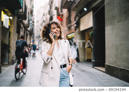 Happy girl using cell for talking 89194194