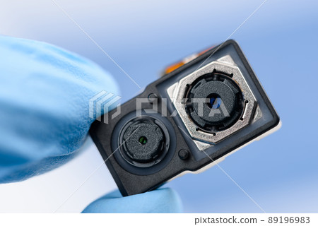 Smartphone dual camera sensor system module in scientist hand 89196983