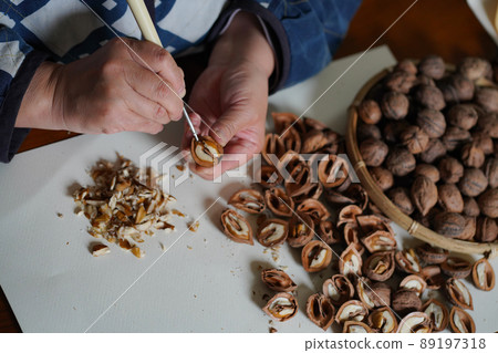 A woman taking out walnuts A woman taking out walnuts 89197318