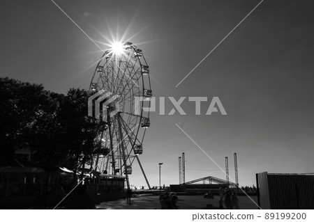 White ferris wheel on blue sky background in sunny day White ferris wheel on blue sky background in sunny day 89199200