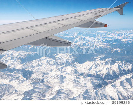 Airplane wing. View from plane window. Travel and transport concept Airplane wing. View from plane window. Travel and transport concept 89199226