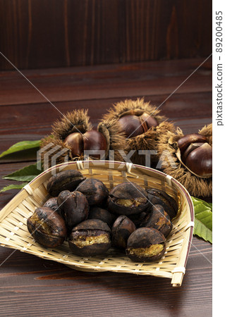 Roasted chestnuts served in a colander Roasted chestnuts served in a colander 89200485