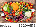 A lot of fruits, vegetables and berries sprinkled on a wooden background in the form of a frame. 89200658