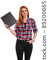 Smiling young redhead woman holding a notebook 89200665