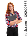 Smiling young woman holding a notebook 89200666