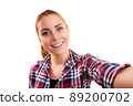 Young smiling woman taking a selfie 89200702