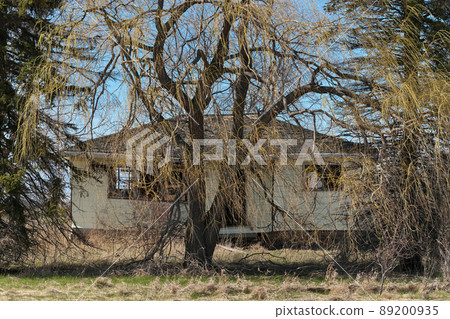 Spooky and Creepy Abandoned Derelict Crumbling Home in Rural Setting 89200935