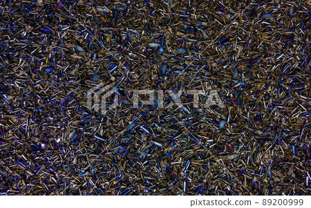 Colored black Steel Chips flat background with natural thermal surface hardening discoloration 89200999