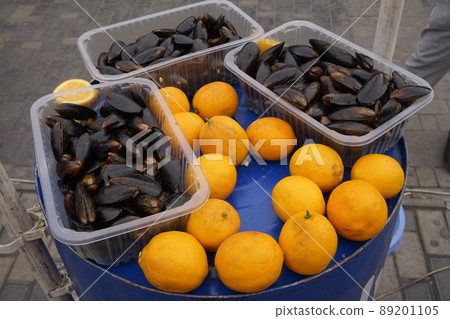 Mussels in the shell with lemon on blue iron background. 89201105