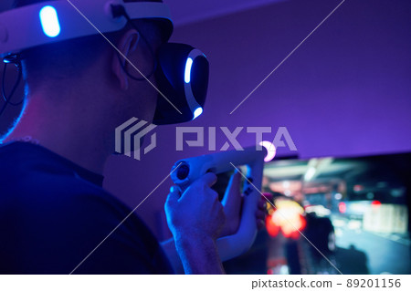 Man with virtual reality headset and joystic is playing game 89201156