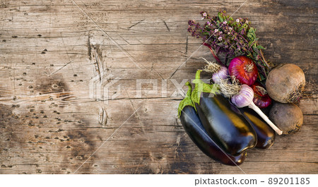 A bunch of purple vegetables on a wooden background. 89201185