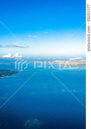 Aerial view from an airplane departing from Shimojishima ・ Irabu Ohashi Bridge and the blue sea that connect Miyakojima and Irabujima Aerial view from an airplane departing from Shimojishima ・ Irabu Ohashi Bridge and the blue sea that connect Miyakojima and Irabujima 89201377