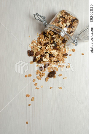 Oatmeal with nuts and raisins. Scattered on the table. Flat lay 89202039